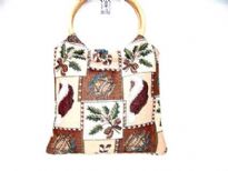 Cotton Tapestry Bag made with a wood double ring handle. Bag has a patchwork pattern.