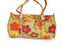Beach bag has a floral pattern, a top zipper closure and double shoulder straps.  Made of 100% Cotton.  