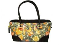 Double strapped fashion bag embellished with a beautiful flower design and a top zipper closure. 