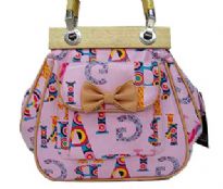Fashionable shoudler bag has a multi color letter pattern, a top zipper closure, a double handle, and an outside pocket with bow detail. Made of faux leather.