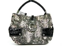 Animal print Fur fashion handbag embellished with a top zipper closure with a hanging bracelet handle and a single shoulder strap.  Outer bold compartments also accentuate this bag. 
