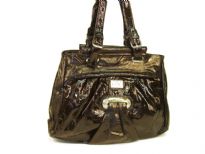 Fashion Handbag made of polyurethane material. This is a double strap bag with belt buckle like straps and a top zipper closure. 