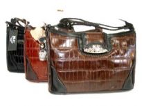 Genuine Leather handbag with clasp over zipper closure.