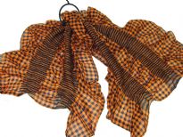 This checkered print orange & black 100% polyester scarf can be a perfect accessory all year round. The scarf is stretched in the middle with a striped pattern & gives a ruffled look. Imported.