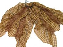 This checkered print 100% polyester scarf in light brown can be a perfect accessory all year round. The scarf is stretched in the middle with a striped pattern & gives a ruffled look. Imported.