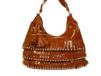 PVC fashion Hobo Handbag has studded details has a metallic texture, a top zipper closure, and a single strap. Made of faux leather.
