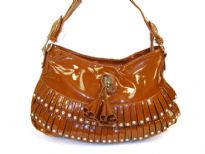 Fashion shoulder bag has a top zipper closure, a single strap and layered frilla with stud details on them. Made of PVC.
