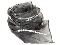 This sheer scarf in deep charcoal color is embellished with vertical stripes of sequins. Mirror embellishments also in between vertical stripes of sequins. 100% shiny polyester scarf is very lightweight. Hand wash. Imported. 