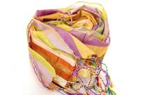 Stripes in multi colors galore over this shiny polyester scarf with also lines of translucent sequins along its length. Thin fringes on its ends completes this 100% polyester scarf. Hand wash. Imported.