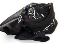 100% polyester scarf in floral design. Main color in Black. Hand washable. Size is approximately 72x40 inches. Made in India.