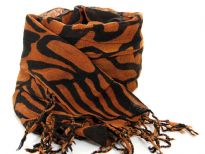 Abstract artistic lines travel over this two-tone rich colored scarf in rust & black colors tipped with twisted fringe. 100% wool scarf; imported. Dry clean only. 