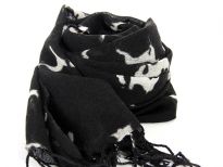 Different abstract animals in white color of all sizes are running over this black wool scarf framed with long twisted fringe. Imported. Dry clean only.