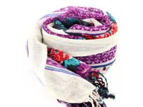 Add a punch of color with this black vivid wool scarf patterned with floral design in blue, red & purple colors and cream colored border along the vertical length. Hanging fringe decorates the ends. 100% woolen scarf. Hand wash. Imported.