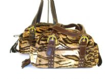 Tiger Pattern Faux Fur Bag has top zipper closure, adjustable belted double handle, two open side pockets & open pocket in the middle front. 