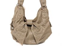 Fashion Hobo bag has a top zipper closure, a double handle and a studded bow detail. Made of faux leather.
