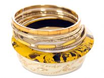 Artistically designed 7 piece fashion bangles set has one ivory 2.5" diameter bangle with gold etched design, yellow/black paint wooden bangle& 5 thin bangles with its own etched design. Lightweight & durable costume jewelery set can be worn with any kind of outfit.