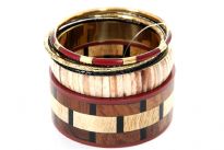 Cherry & wood colored wide cuff bangle with beige color patterned resin bangle comprises this six piece bangles set. Two thin black resin bangles, one cherry/gold colored & one gold colored metal bangle are the other bangles in this set. Imported.