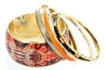 Exotic print in orange & black colors decorate the wide cuff gold colored bangle in this six piece bangles set. Five other bangles comprises of one orange, one black resin bangle & three gold colored metal bangles in different designs/width. Imported. 