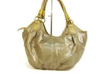 Designer Inspired Hobo Shoulder Bag with metallic texture, zipper closure and a double handle. Made of PU (polyurethane).