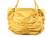 Spacious fashion shoulder bag has a ruched front, top zipper closure and a double handle. Made of PU.