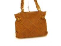 Designer Inspired Lattice-Finish Handbag has a zipper closure and a braided double handle. Made of faux leather.