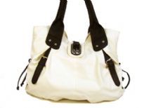 Pvc handbag  with zipper accents in the front & straps like accents on the sides of the bag. Buckle as well as zipper closure on the top. 