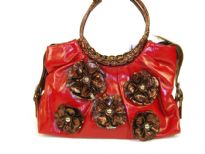 PVC Flower Handbag with round double handle & belt accents on the sides of the bag. Floral patchwork in contrasting color makes the bag very trendy & fashionable.