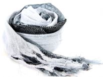 This lightweight 50% viscose & 50% polyester scarf in black, grey & white shades with silver stripes running through it can be used all year around to give an edge to your outfit. Long knotted tussels on its edges. Imported.