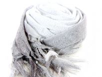 This lightweight 50% viscose & 50% polyester scarf in grey, silver & white shades with silver stripes running through it can be used all year around to give an edge to your outfit. Long knotted tussels on its edges. Imported.