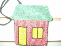 Multi color beaded coin purse in the shape of hut. Top zipper closure with wrist strap also. Imported.