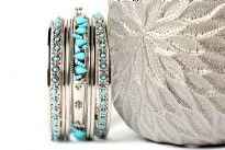This sparkling silver metal 9 pieces set can be matched with any kind of outfit during day or at night. Set includes 6 plain thin bangles, 2 similar round beads bangles & one wide metal pattern bangle with turquoise beads. 
