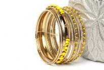 This gold colored metal 9 pieces set can be matched with any kind of outfit during day or at night. Set includes 6 plain thin bangles, 2 similar round beads bangles & one wide metal pattern bangle with yellow beads. 