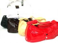 PVC Handbag has a top zipper closure and a single strap. Small diamond details along center. 