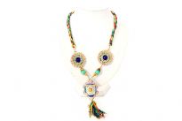Tantalizing neck piece has colorful twisted thread as string with patterned round metal accents & metal pendant adorned with colored threads & stones. Colored threads & golden chains make a hanging tussel. Imported. 