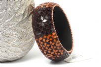 Beautiful wide cuff fashion bangle has small mirrors in brown & orange making a floral pattern all over the bangle. Made of Resin and is very lightweight. 