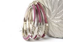 Beautifully hand crafted 9 pieces set of stylish bangles includes 3 purple colored resin bangles encrusted in silver colored metal frame & 6 skinny bangles either etched or plain. Rich color of these bangles makes them attractive & reflects expertise to craft them. Fits small to medium size wrist.