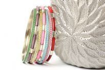 This is a 7 piece set of bangle bracelets in assorted colors. Handcrafted by expect artisans in India.