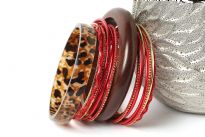 This fashion bangles set includes 16 pieces in total with 2 wide wooden bangles & 14 thin bangles. Thin bangles are plain as well as glittered. Ethnic as well as trendy look & can be matched with any kind of outfit.