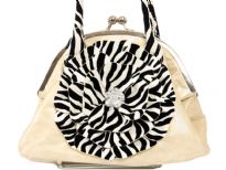 Shining PVC Handbag with zebra print double handle & cut out flower applique at front. Kiss lock closure of the bag. Imported. 