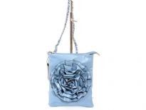 Crossbody bag has a top zipper closure, a detachable strap and a large flower detail. Made of faux leather.