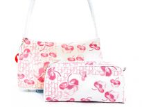 Shoulder bag has a cotton flower pattern, a top zipper closure and a single strap. Cosmetics bag has a top zipper closure. Made of jacquard.
