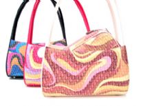 Designer Inspired jacquard Handbag. Shoulder bag with abstract artwork design. Bag has a single strap and a top zipper closure. 