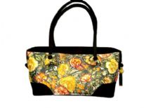 Double strapped fashion bag embellished with a beautiful flower design and a top zipper closure. 