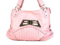 Designer Inspired Shoulder Bag with accentuating metal design. Bag has a zipper closure and a double handle. Made of polyurethane.