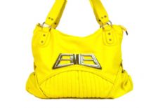 Designer Inspired Shoulder Bag with accentuating metal design. Bag has a zipper closure and a double handle. Made of polyurethane.