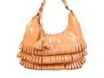 PVC fashion Hobo Handbag has studded details has a metallic texture, a top zipper closure, and a single strap. Made of faux leather.