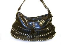 Fashion shoulder bag has a top zipper closure, a single strap and layered frill in same fabric with studs on them. Made of PVC.