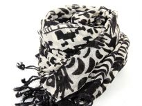 This 100% wool scarf in ivory color has artistic abstract figures print on it in black color. Has twisted fringes at its edges. Imported. Dry clean only.