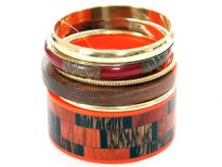Artistic boxy pattern wide cuff bangle in resin & wood in black, brown & orange colors included in this 6 piece bangles set. Another orange/wood colored resin bangle, 2 thin gold bangles & 2 more 1 cm wide bangles in burgundy/gold colors. This set can  give funky look to any simple outfit.