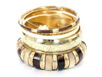 Chunky look five piece bangles set includes one rounded coffee/gold aluminium bangle, one gold wide bangle & 3 thin bangles each of them in different color & style. Trendy looking bangles set can be matched with any kind of outfit. 